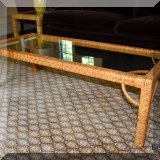 F76. Midcentury rattan coffee table with glass top. 